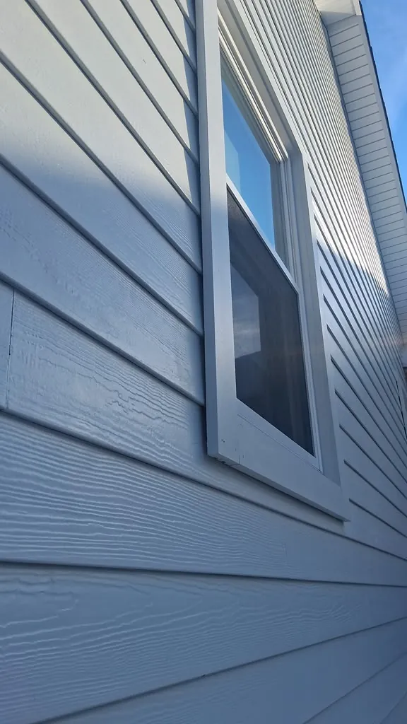 Close-up detail of fiber cement lap siding and window trim